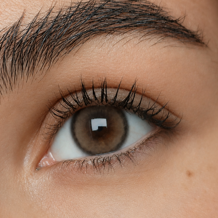 Just Be Mystique Brown natural brown coloured contacts shown on dark brown eyes