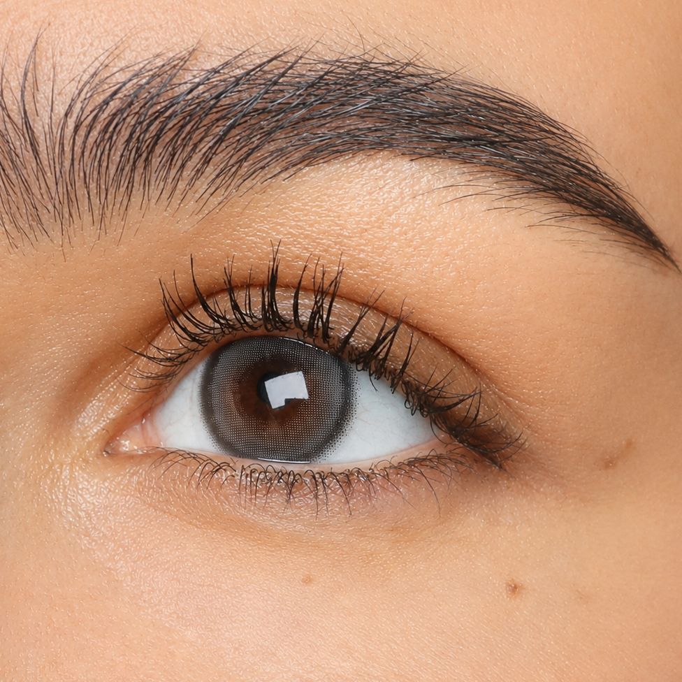 Just Be Mystique Grey smoky grey coloured contacts shown on dark brown eyes